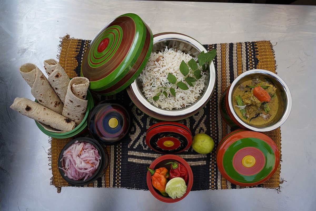 Rice, chapati and curry served in traditional dishes